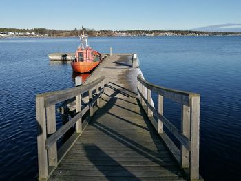 Pier over sea against clear sky