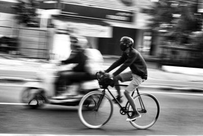 Man riding bicycle on street in city