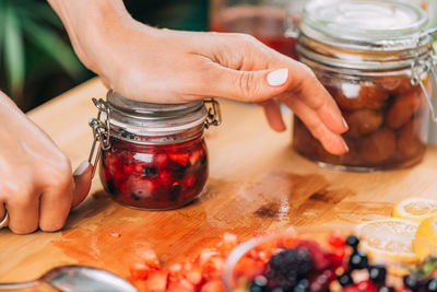 Fruit fermentation. woman holding jar with fermented fruit.