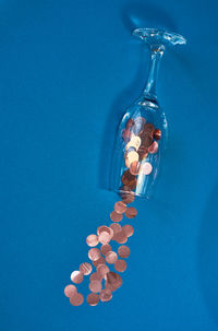 Close-up of illuminated light bulb against blue background