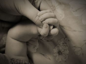 Close-up of baby lying on bed