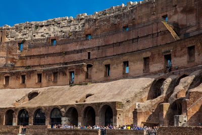 Tourists visiting the interior of the famous colosseum in rome