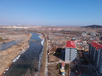 High angle view of river amidst buildings in city