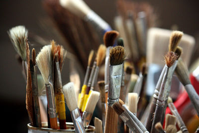 Close-up of various brushes in desk organizer
