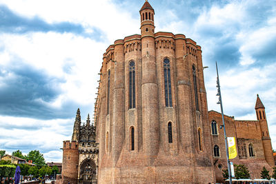 Low angle view of historic building against cloudy sky