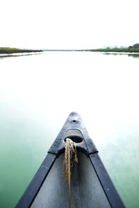 Close-up of boat sailing on sea against clear sky