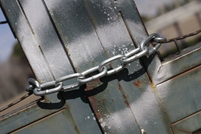 Close-up of padlock on metal chain