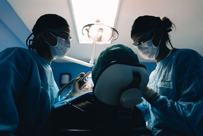 Dentists examining patient in clinic