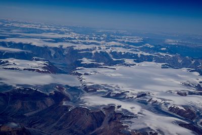 Aerial view of snowcapped mountains against sky