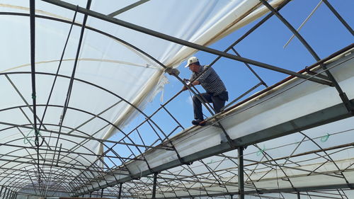 Low angle view of man working at construction site