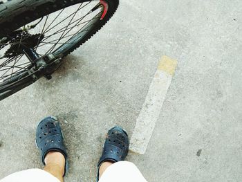 Low section of man standing on road