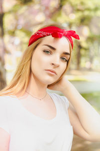 Portrait of young woman wearing red bandana outdoors