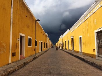 Street amidst buildings against sky