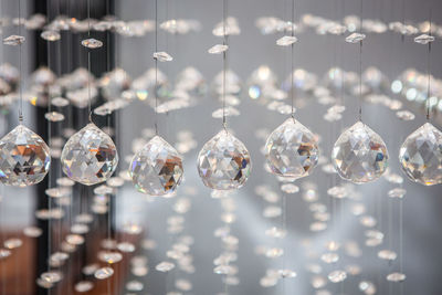 Close-up of christmas lights hanging from glass