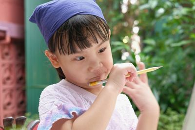Portrait of cute boy holding camera
