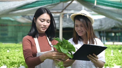 Young woman holding mobile phone outdoors