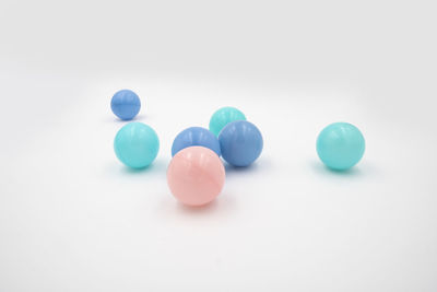 Close-up of multi colored candies against white background