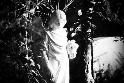 Statue of buddha against plants