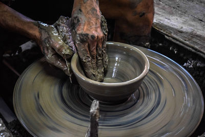 Close-up of man working in mud