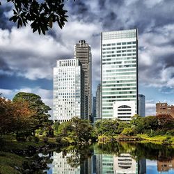 Low angle view of buildings against cloudy sky