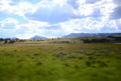 Scenic view of landscape against cloudy sky