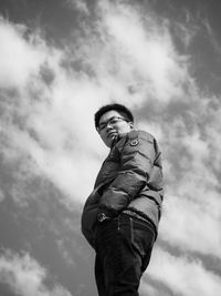 Low angle view of man standing against sky