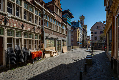 Street amidst buildings in city against sky