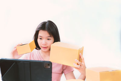 Portrait of a beautiful young woman sitting in box