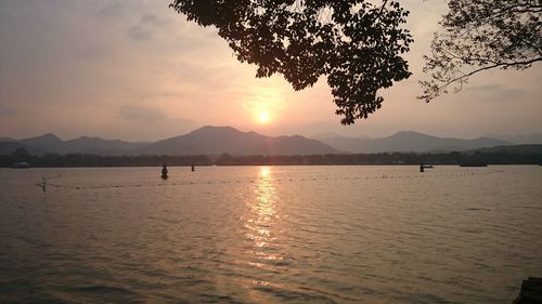 Scenic view of lake against sky during sunset