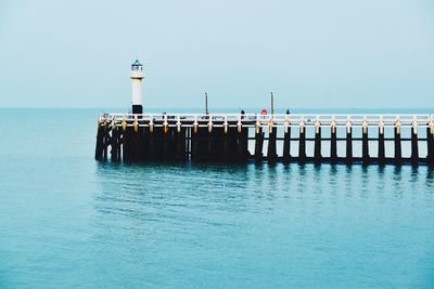 Pier over sea against clear sky