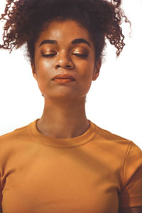 Portrait of young woman against white background