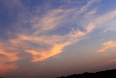 Low angle view of cloudy sky at sunset