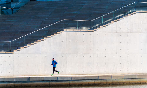 Man jogging against steps