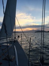 Boats in sea at sunset
