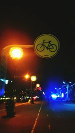 Illuminated road sign at night