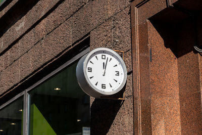 Low angle view of clock on wall of building