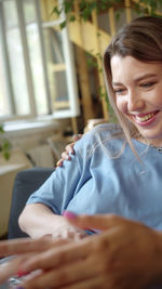 Close-up of cute girl sitting on table