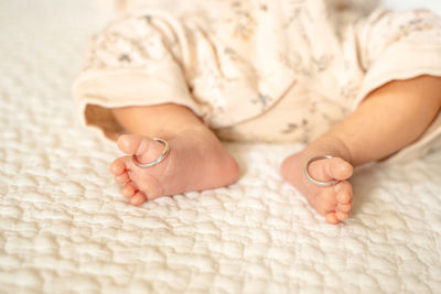 Low section of baby feet on bed