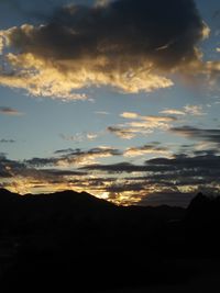 Scenic view of silhouette mountain against dramatic sky