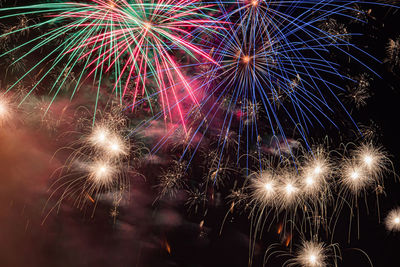 Low angle view of firework display at night