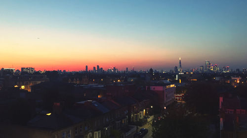 High angle view of illuminated buildings against sky during sunset