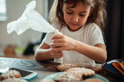 Close-up of girl looking at table