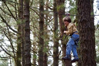 Side view of boy in forest