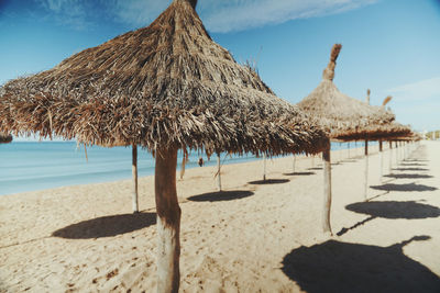 Scenic view of beach against cloudy sky