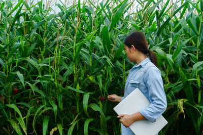 Side view of a woman standing in field