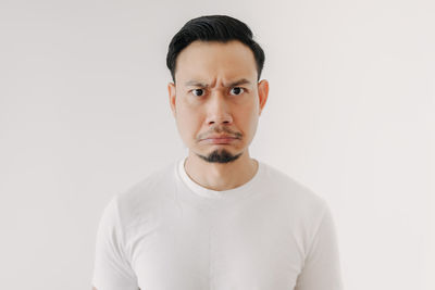 Portrait of young man against white background