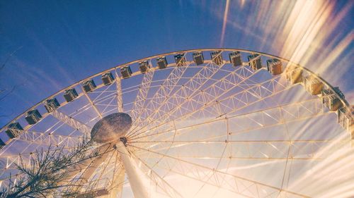 Low angle view of ferris wheel against sky