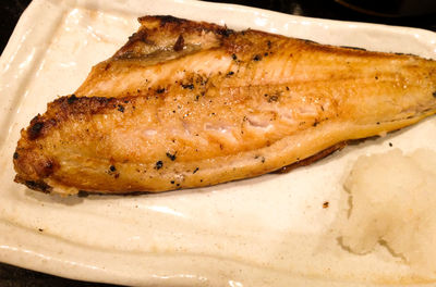 Close-up of roasted fish served in plate