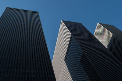 Low angle view of buildings against clear blue sky