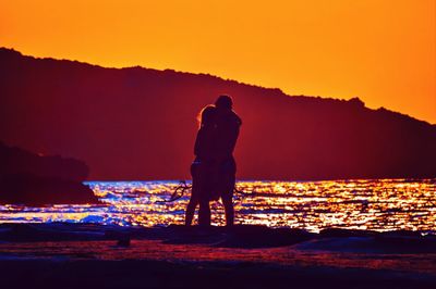 Silhouette of people at sunset